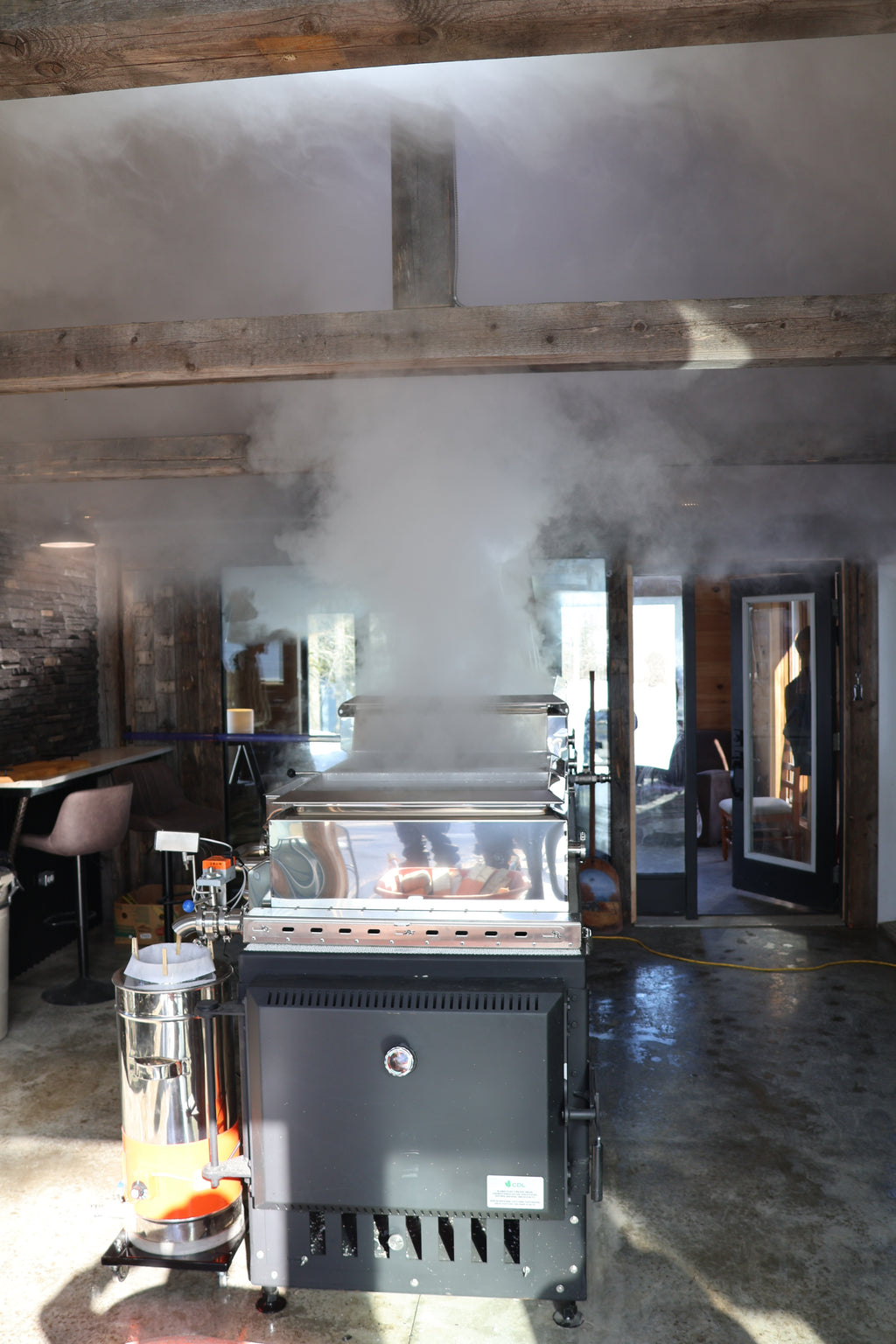 Evaporator for producing maple syrup in a cabin.